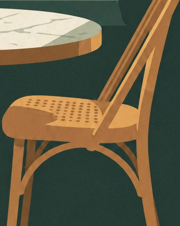 A golden wooden chair with a cane seat beside a round marble table