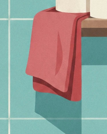 Une serviette rouge pliée sur le bord d’une étagère devant le carrelage turquoise