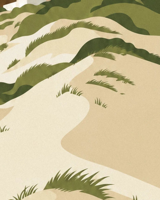 The curves of golden sand and clumps of green marram grass on the dune