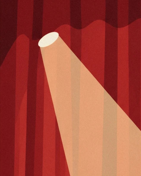 A spotlight beam falling diagonally across the red velvet curtain