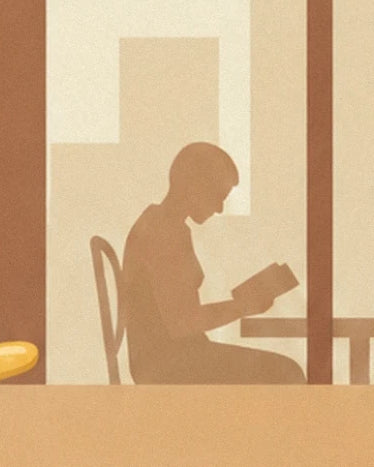 The brown figure of a person sitting and reading by the window