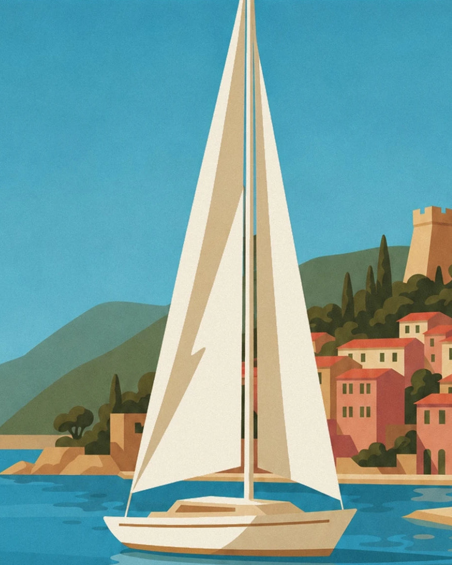 The sailing boat with cream sails in front of the colourful façades of Villefranche-sur-Mer