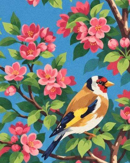 A goldfinch with a red face and yellow wings among pink apple blossom