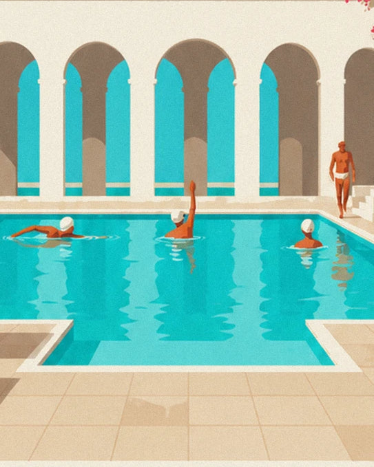 Swimmers in the turquoise water at the foot of the tall cream arches