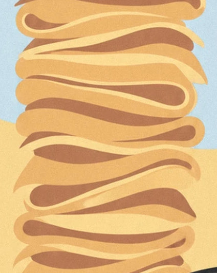 A tall stack of folded crêpes with golden highlights and brown folds
