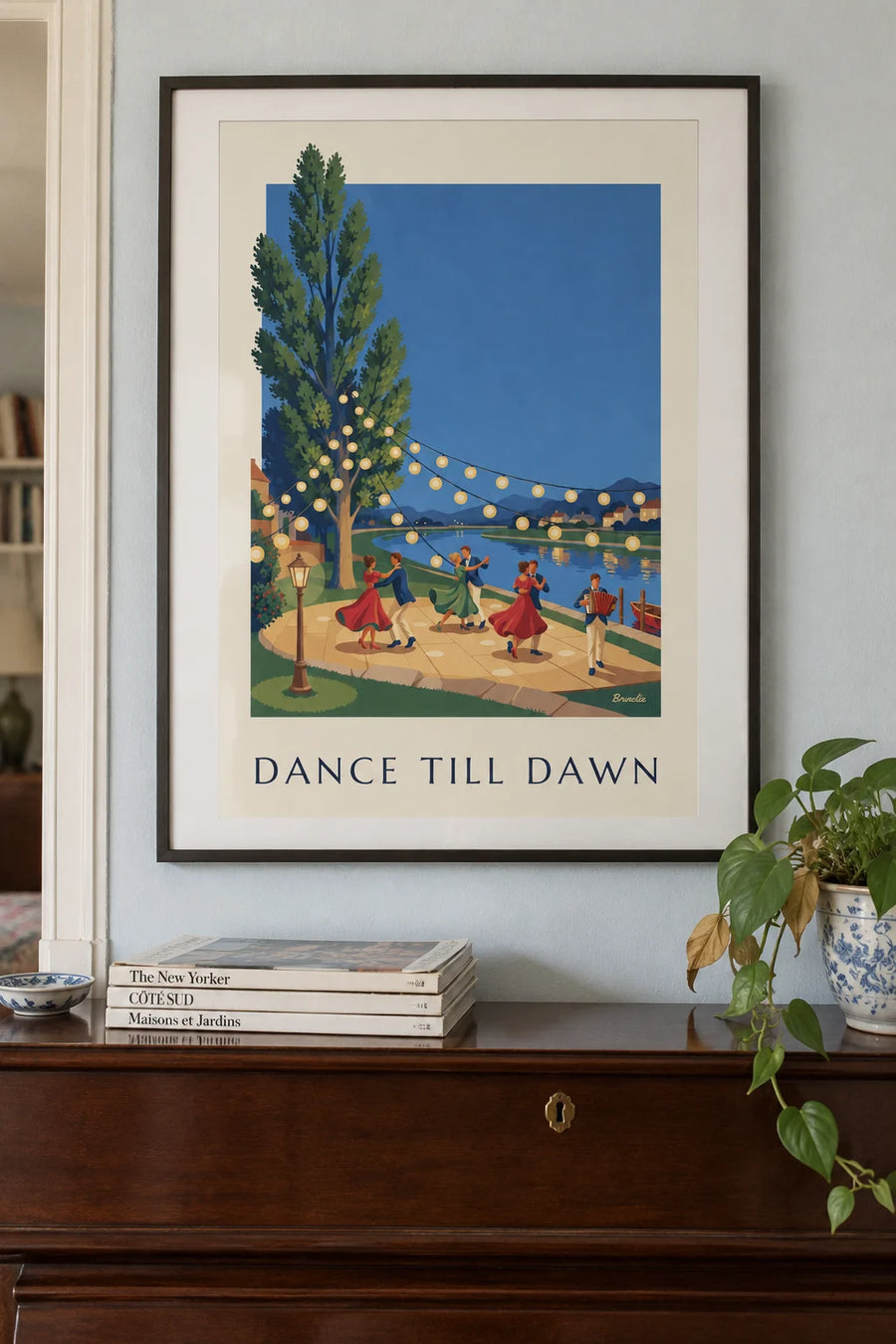Poster of a guinguette dance, dancers under paper lanterns by the water: framed on the wall