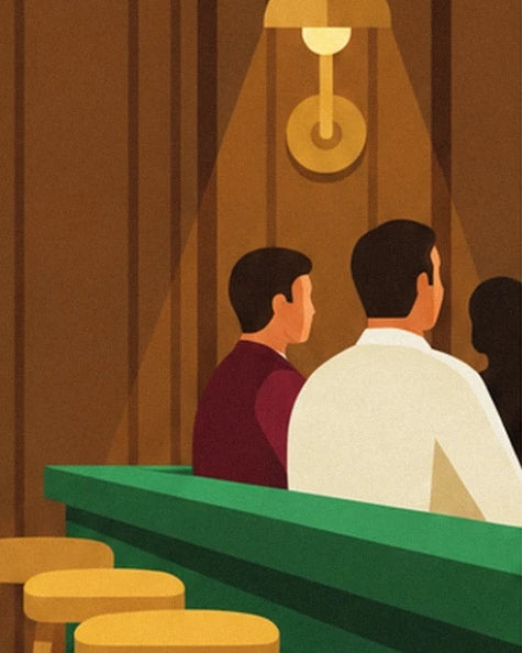 Customers seen from behind leaning on the green bar beneath a gold wall light