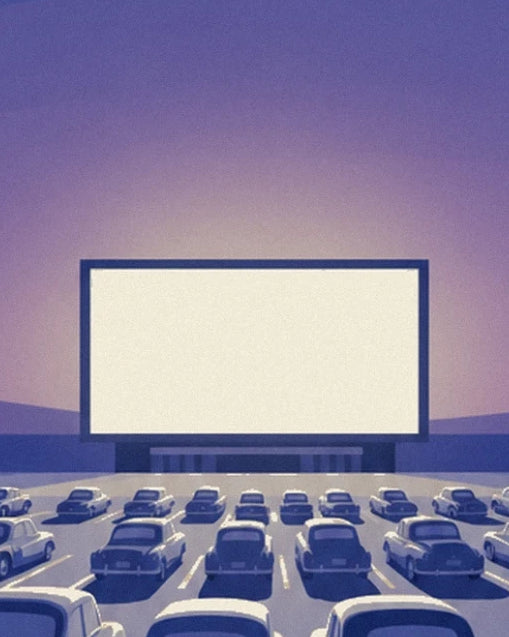 The white drive-in cinema screen facing rows of cars beneath the mauve sky