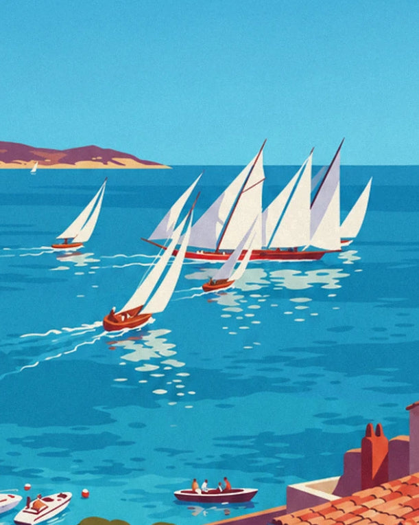 White sailing boats racing on turquoise water at the foot of the coast