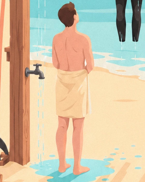 A man seen from behind in a yellow towel under the beach shower, beside the tap