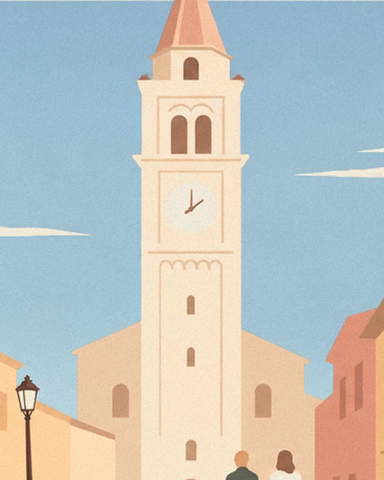 The cream bell tower and its clock against the village's blue sky