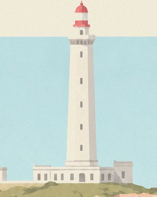 The white lighthouse with a red top and buildings at its base facing the turquoise sea