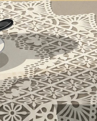 Ivory lace with flower and diamond patterns against a grey-beige background