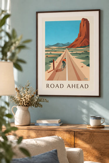 Cycling poster of a long straight road leading to the mountains: framed on the wall