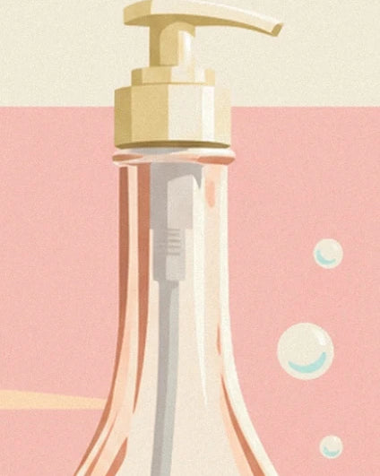 The cream pump on the clear bottle against a pink background dotted with bubbles