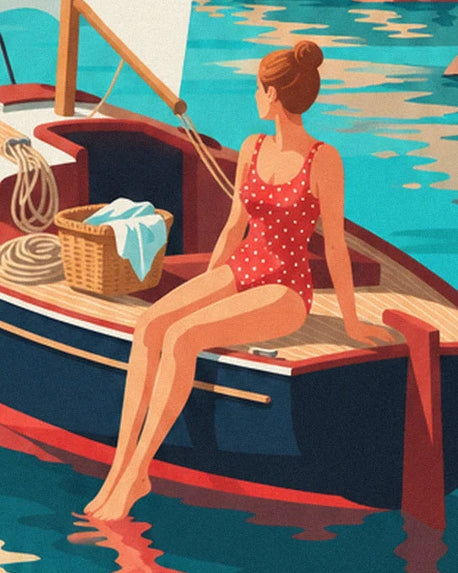 A woman in a red swimsuit with white polka dots, sitting on the sailing boat near a basket