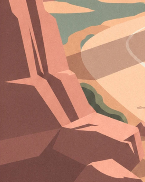 A striated pink rock face, green bushes and the road winding through the canyon