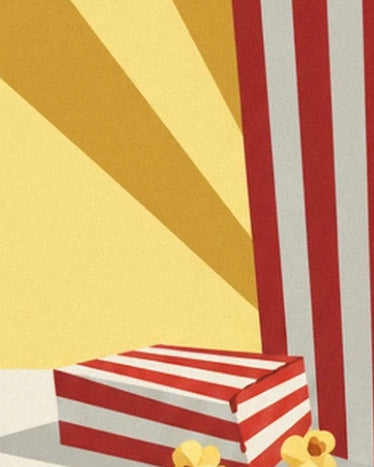 The shallow red and white striped box in front of the large cone, with pieces of popcorn
