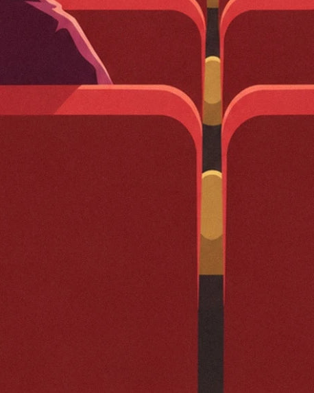 The red backs of the cinema seats and their golden armrests