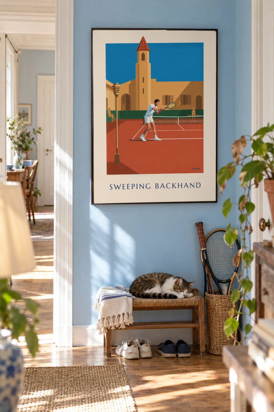 Poster of a tennis player mid-backhand on red clay: framed on the wall