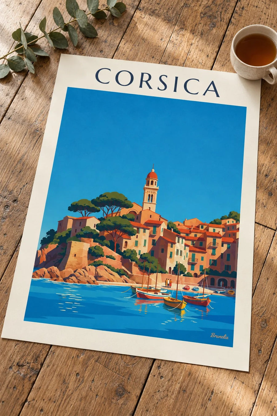 Corsican coastal village and little harbor on the Mediterranean poster: resting on a table