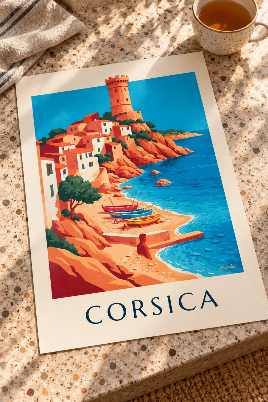 Coastal village, Genoese tower and boats in Corsica poster: laid flat on a table