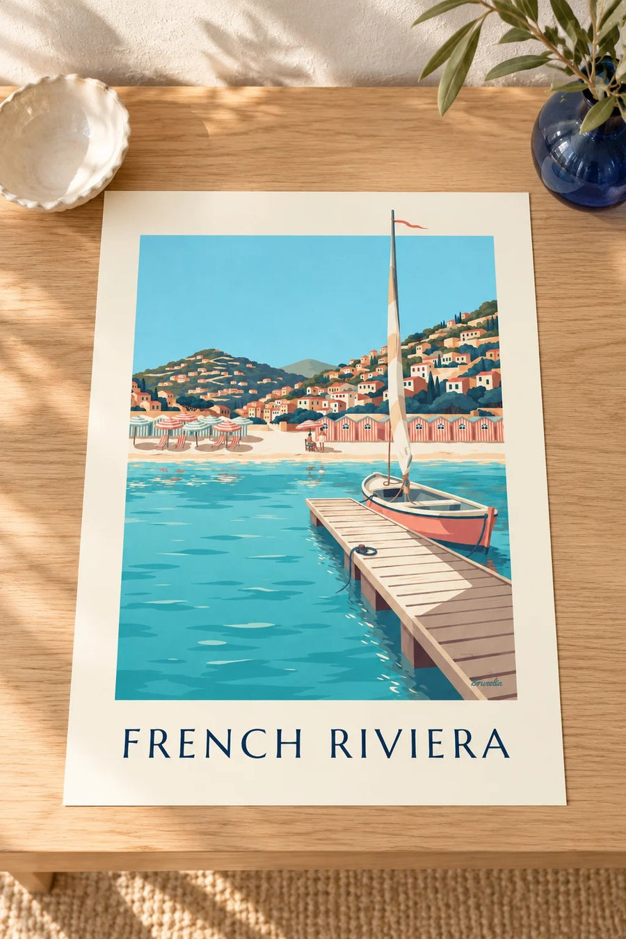 Striped beach cabins and pier on the French Riviera poster: on a table