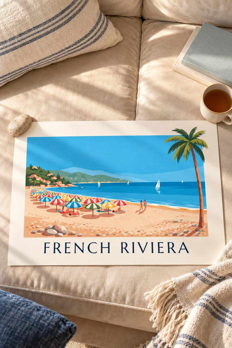 Colorful parasols on a French Riviera pebble beach poster: resting on a table