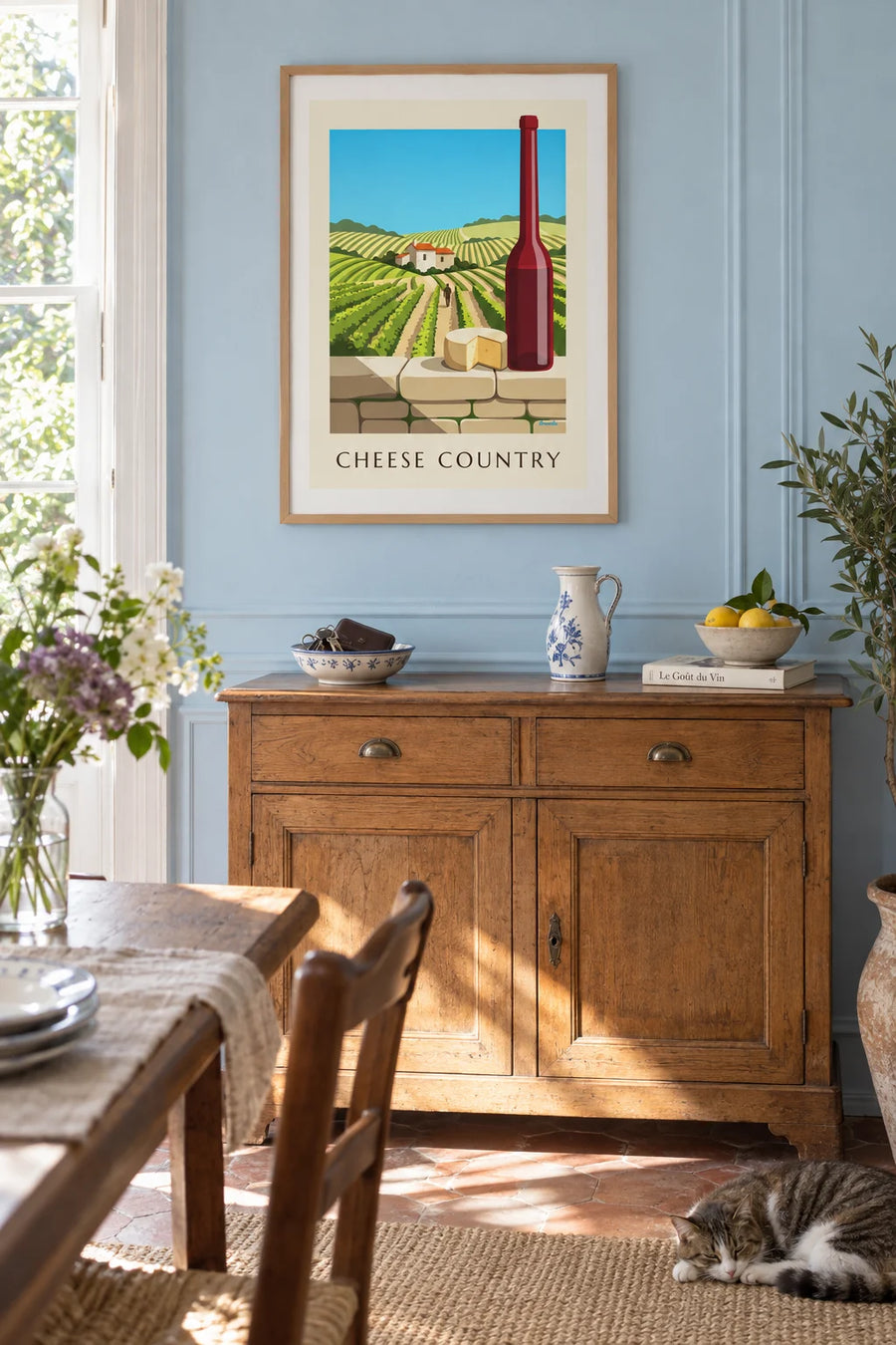 Poster of farmhouse cheese and red wine in front of the vineyards: framed on a wall
