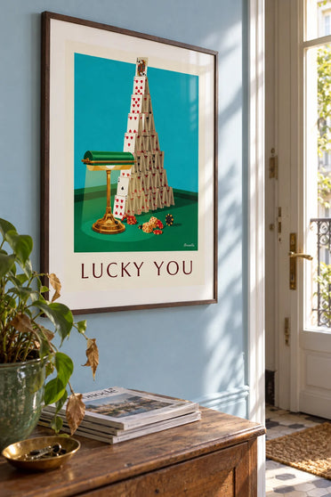 Poster of a house of cards and a crowned queen on a casino table: framed on the wall