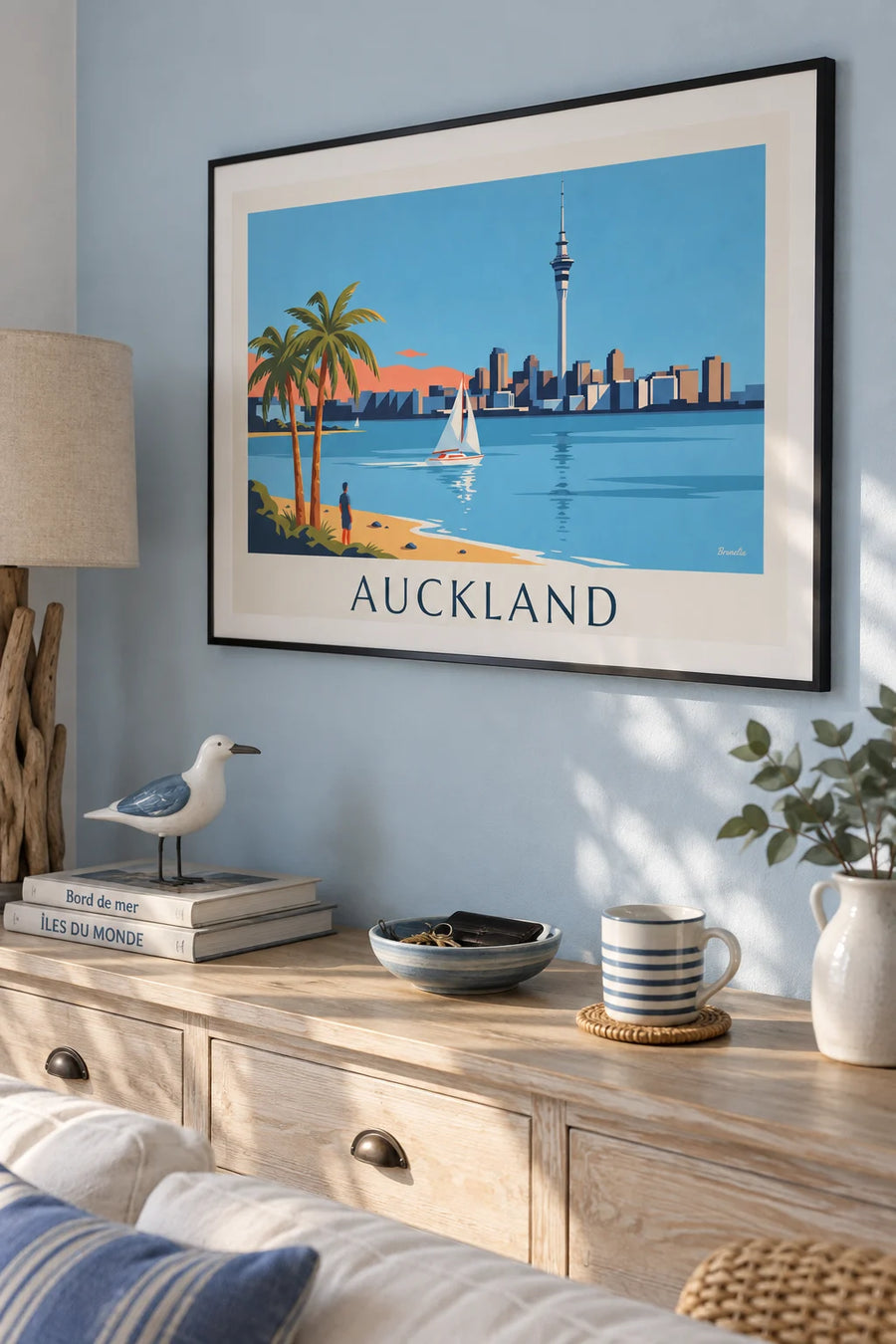 Poster of a sailboat in Auckland harbor and the Sky Tower: framed on a wall